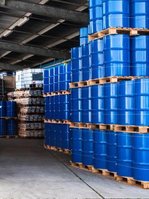 Blue drums and IBC container in a storage room